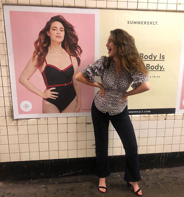 aija mayrock looking at herself in a suit bath